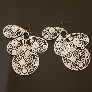 Silver/hanging/flower motif earings.